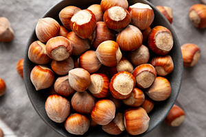 Organic Raw Hazelnuts in a Bowl, top view. Close-up., a Food & Drink Photo by LiudmylaChuhunova