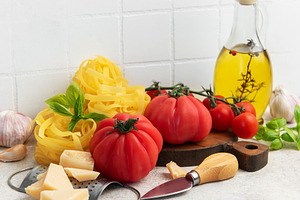 Fresh italian ingredients preparing pasta with tomatoes and basi, a Food & Drink Photo by Olena Rudo