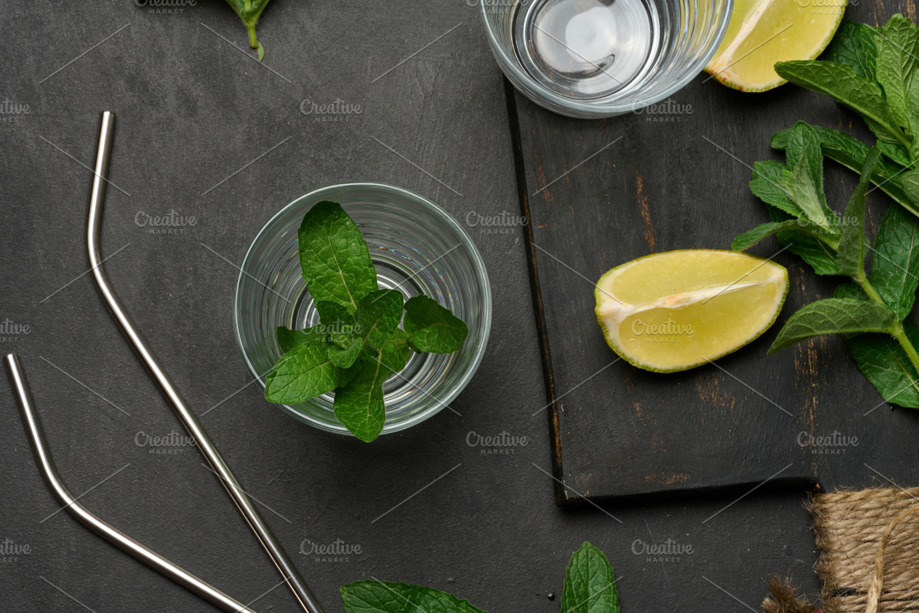 Bunch of fresh green mint, lime slices, glasses, top view. Cockt, a Food & Drink Photo by ndanko