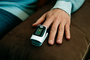 man measuring his blood oxygen saturation, a Photo by Nito