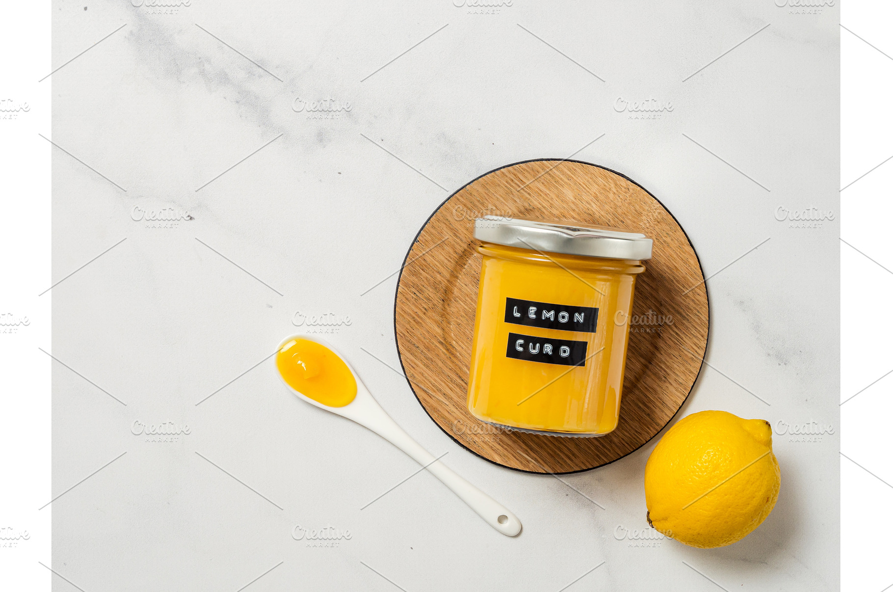 Homemade lemon curd in jar, top view, a Food & Drink Photo by Fascinadora
