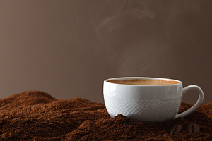 Cup with hot coffee on ground coffee and isolated background, a Food & Drink Photo by Davizro's Market