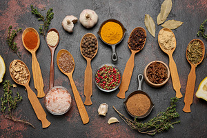 Spices in spoons and bowls on a dark background: turmeric, papri, a Food & Drink Photo by ndanko