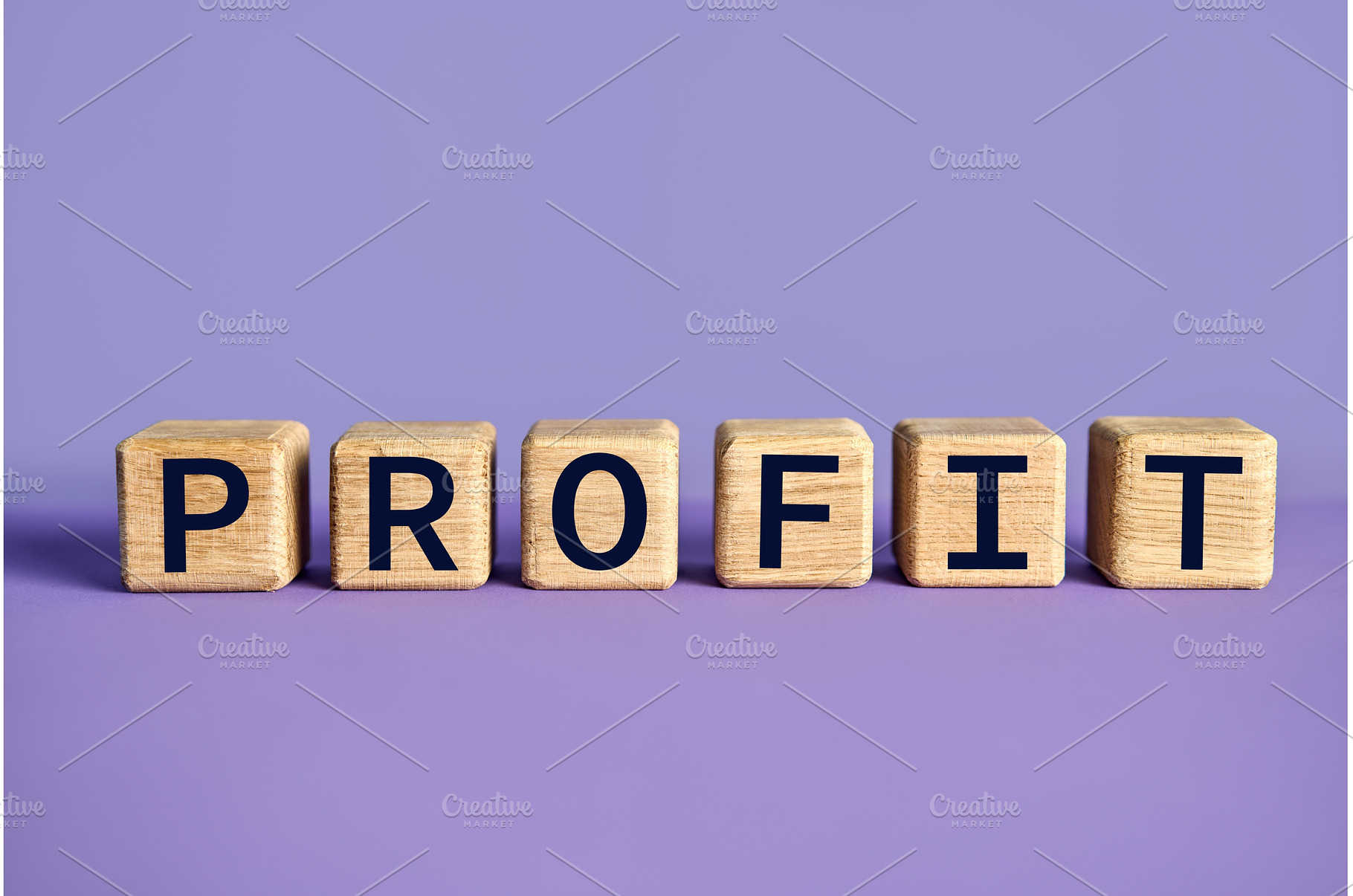 The word PROFIT on wooden blocks, a Business Photo by Gladkov photography