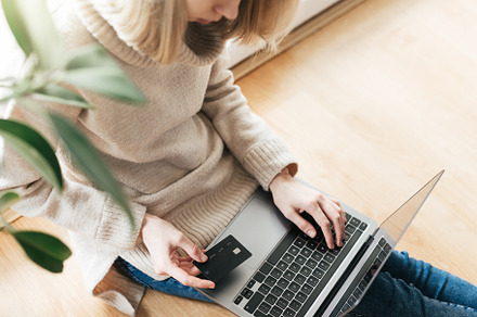 Young woman holding credit card and using laptop computer., a Business Photo by Olena Rudo