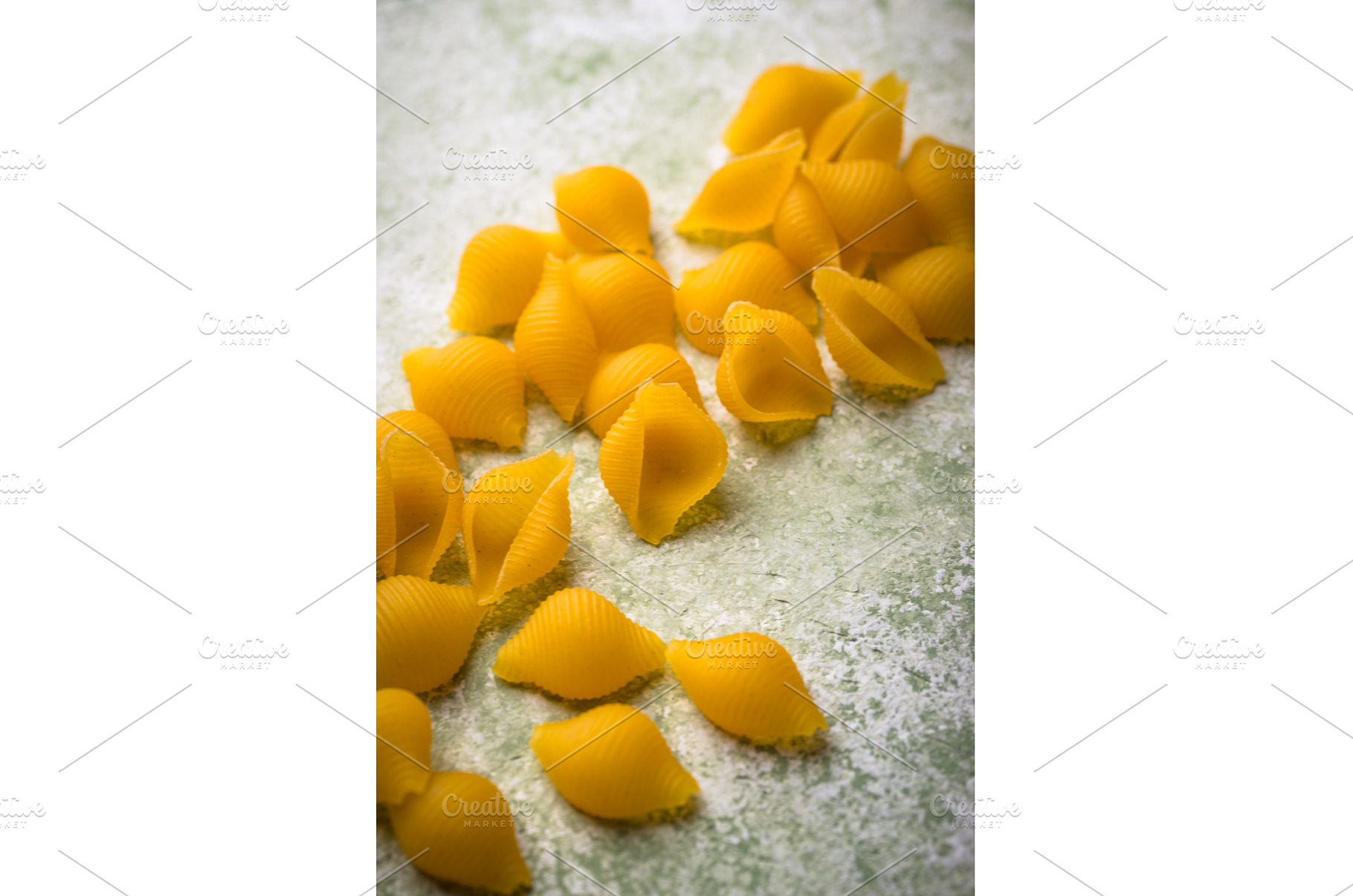 Raw pasta in shape of shells, a Food & Drink Photo by Yulia Furman