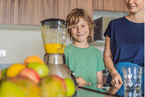 Mother and son cooking together in, a Person Photo by Elizaveta Galitskaya