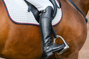 Jockey riding boot in the stirrup.