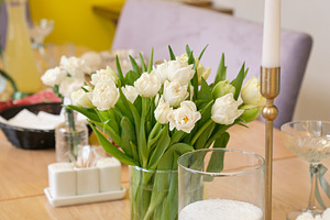 Elegant table setting with white tulips and decorative candle in modern interio, a Food & Drink Photo by Rohan Photography