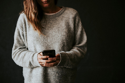 Woman using iphone, stock image