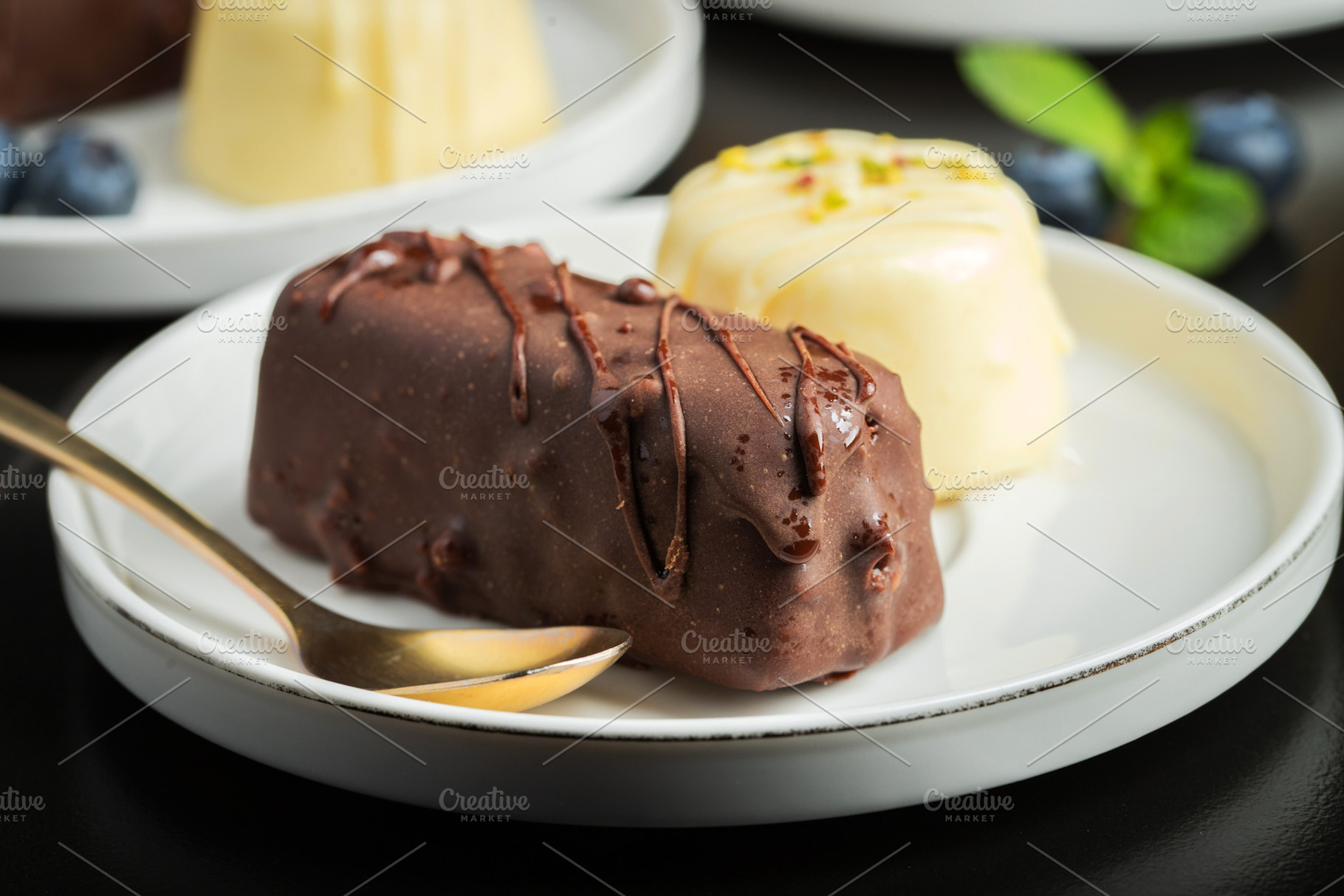 Delicious glazed curd snacks with fresh blueberries and mint on light grey tabl, a Food & Drink Photo by Budarinphoto