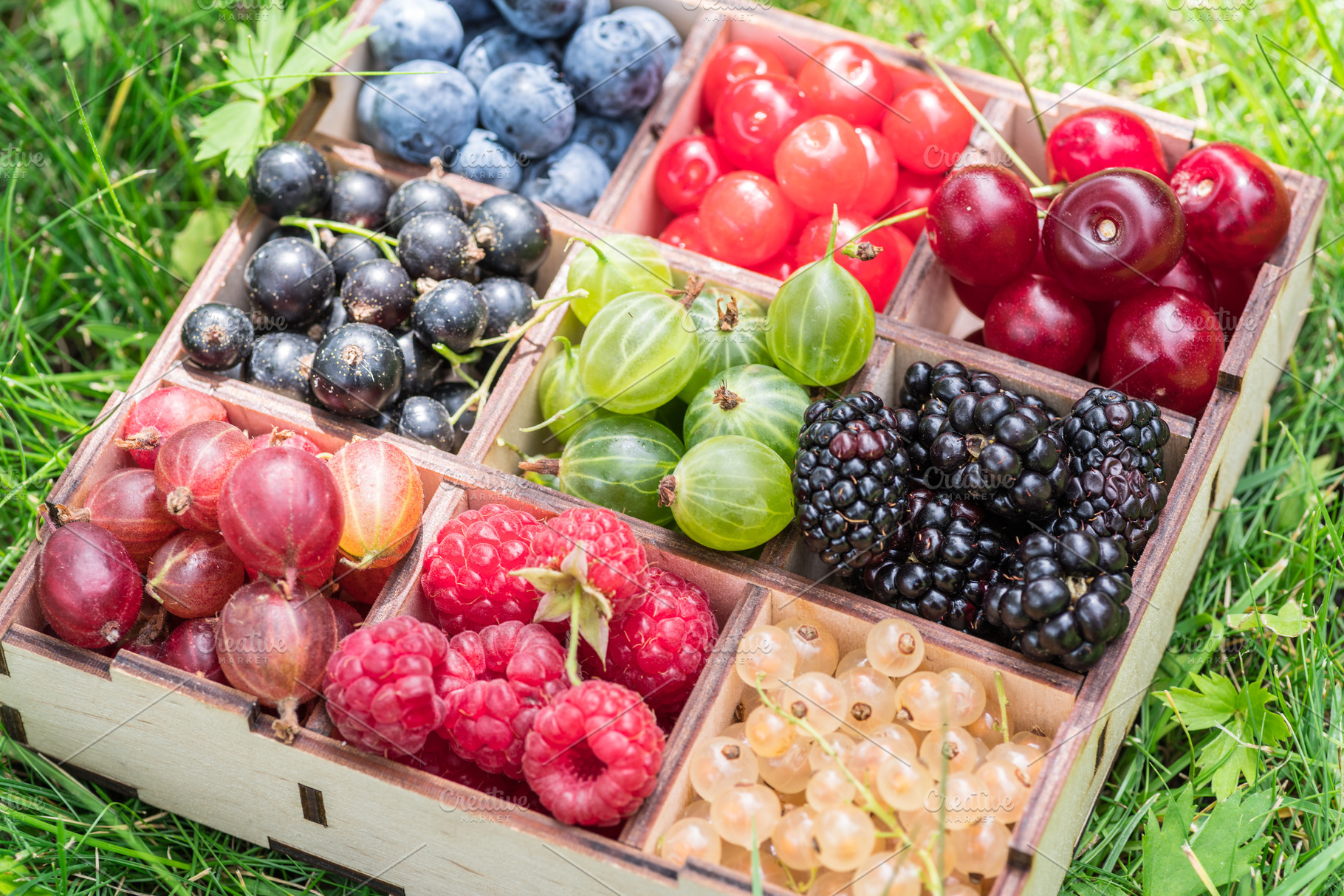 Summer berries in wooden box on the, a Photo by Volff
