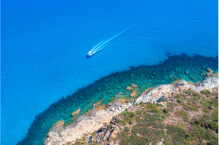Aerial view of boat in blue sea, a Nature Photo by den-belitsky