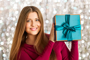 Happy woman holding a beautiful turquoise gift box, celebrating, a Person Photo by Anneleven