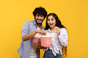 Amazing entertainment, leisure time together. Surprised indian guy and lady eat, a Photo by Prostock-Studio (Thumbnail 3 of 5)