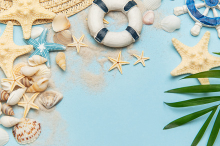 Summer vacation accessories creating a frame on blue background
