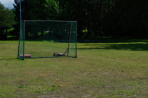Soccer goal on green field at Akranes, Iceland during a sunny day, a Photo by AS photostudio