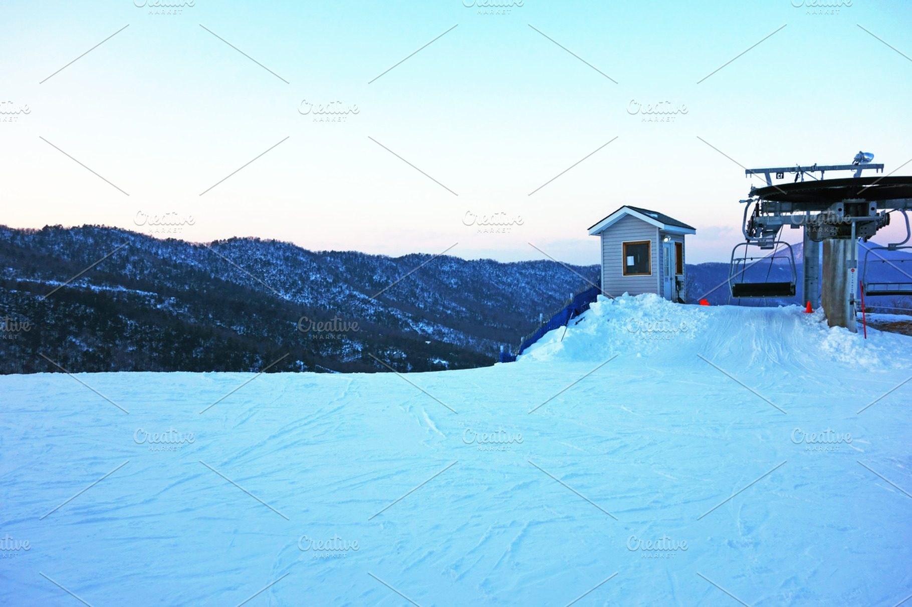 Ski lift featuring snow, lift, and mountain