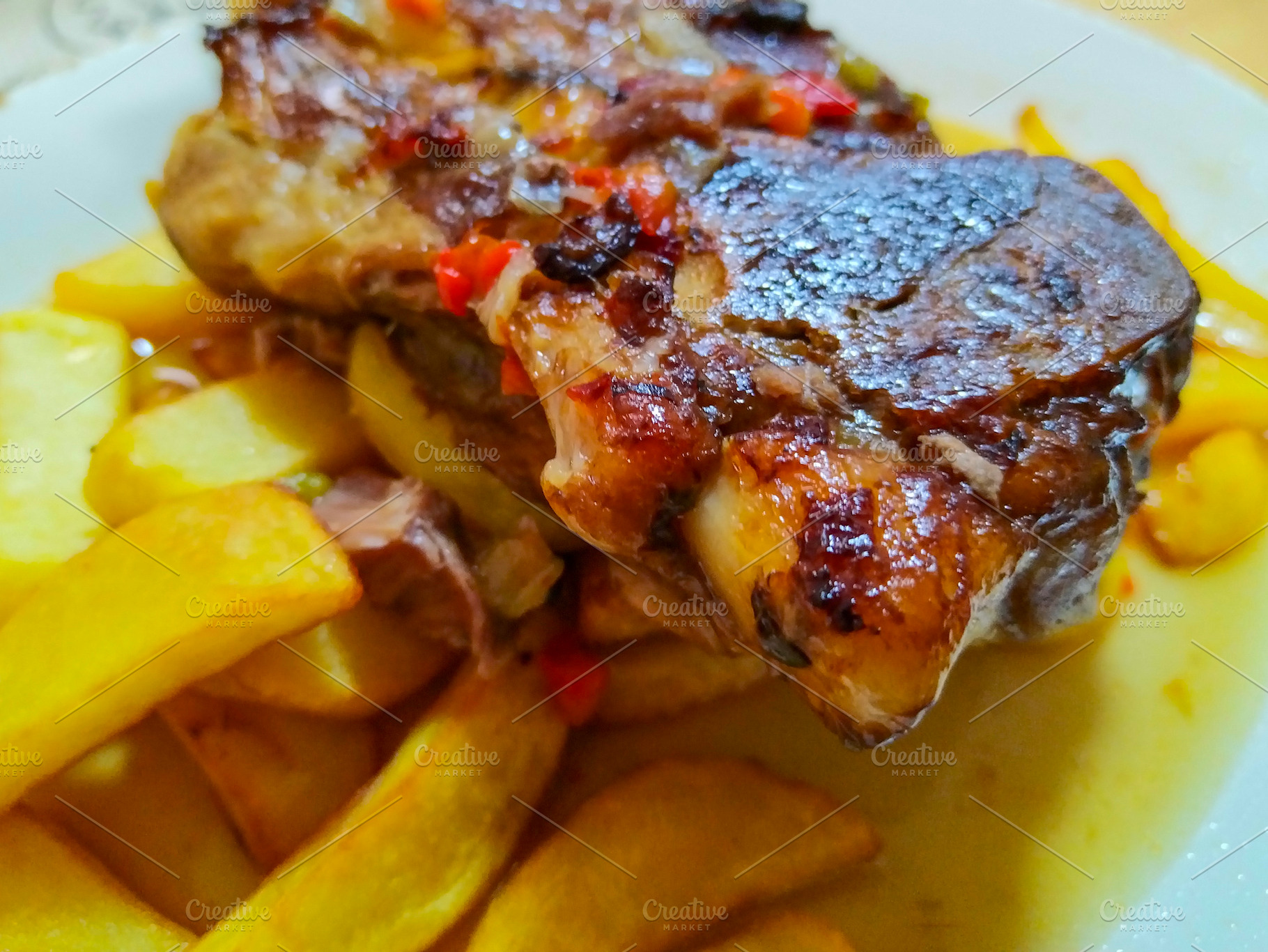 Grilled meats with potatoes on a table, a Food & Drink Photo by DanFLCreativo