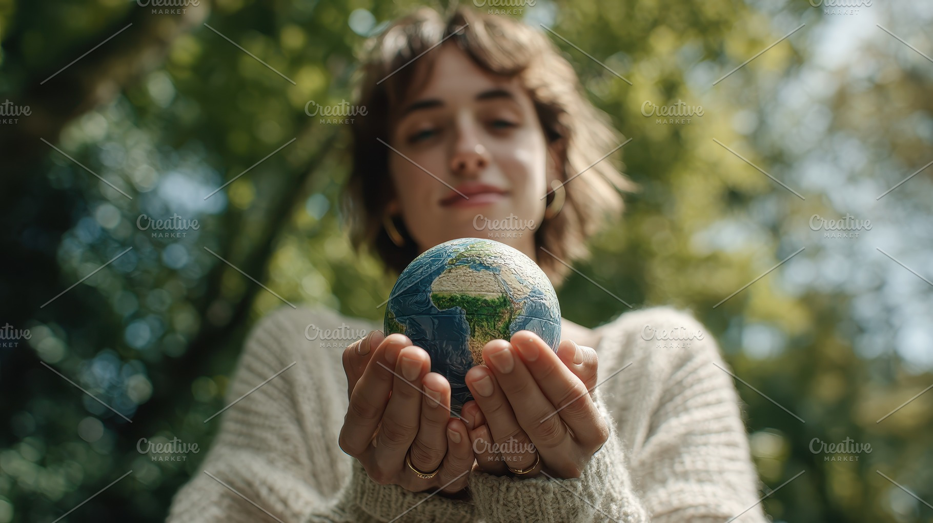 Woman holding small Earth globe outd, a Photo by Pixeness Studio