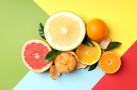 Citrus fruits with leaves on multicolored background, a Food & Drink Photo by AtlasStudio PRO