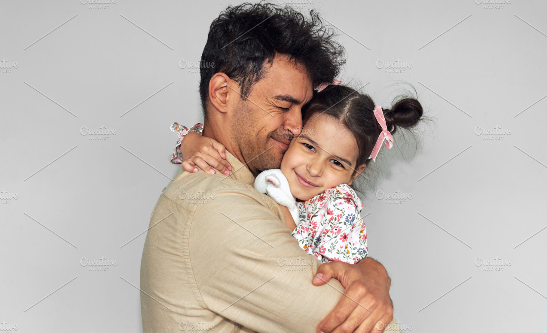 Loving father hugging his daughter a, a Person Photo by yuricazac