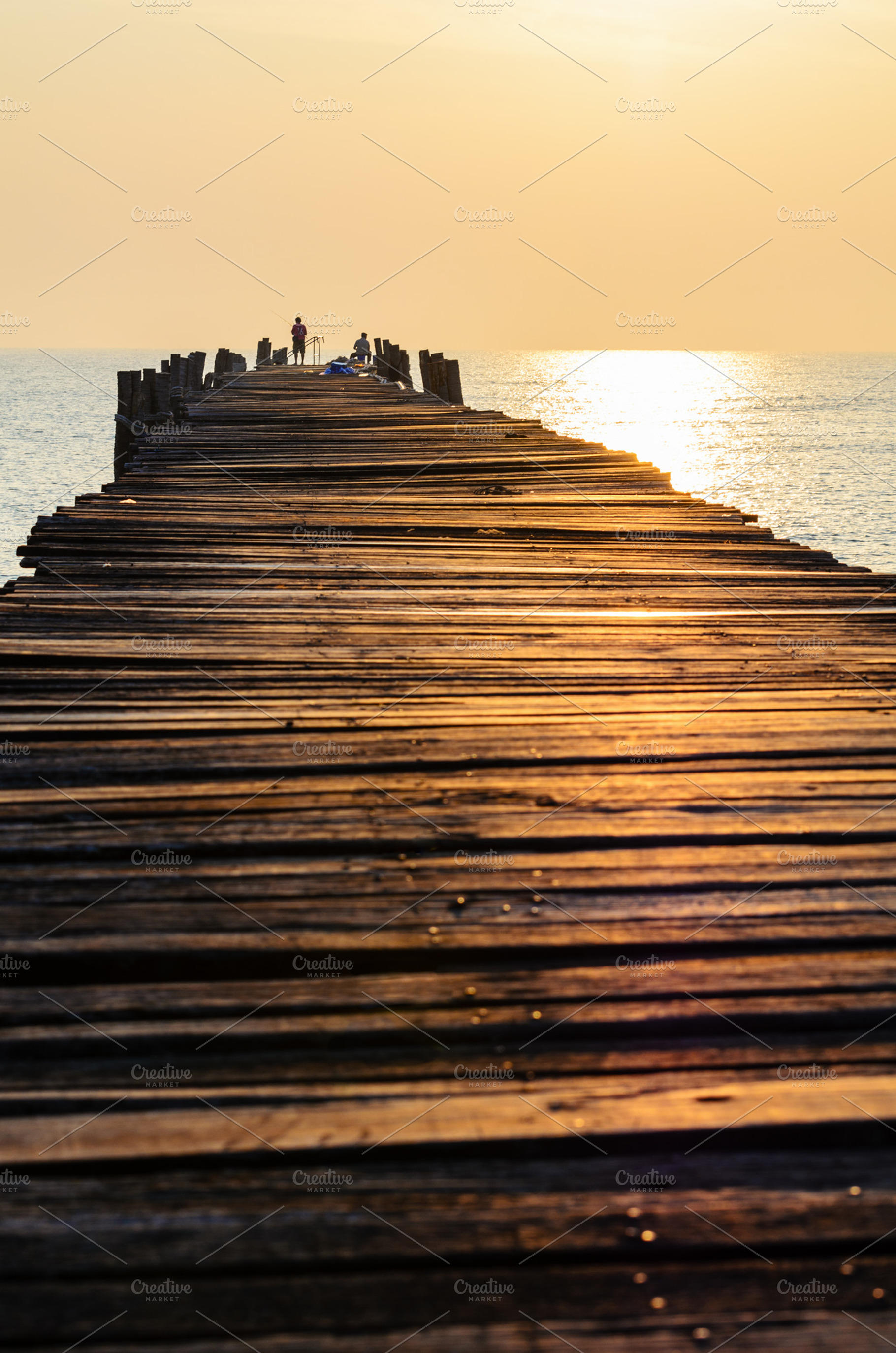 Sea at sunrise stock photo containing bridge and wood, a Nature Photo by yongkiet jitwattanatam