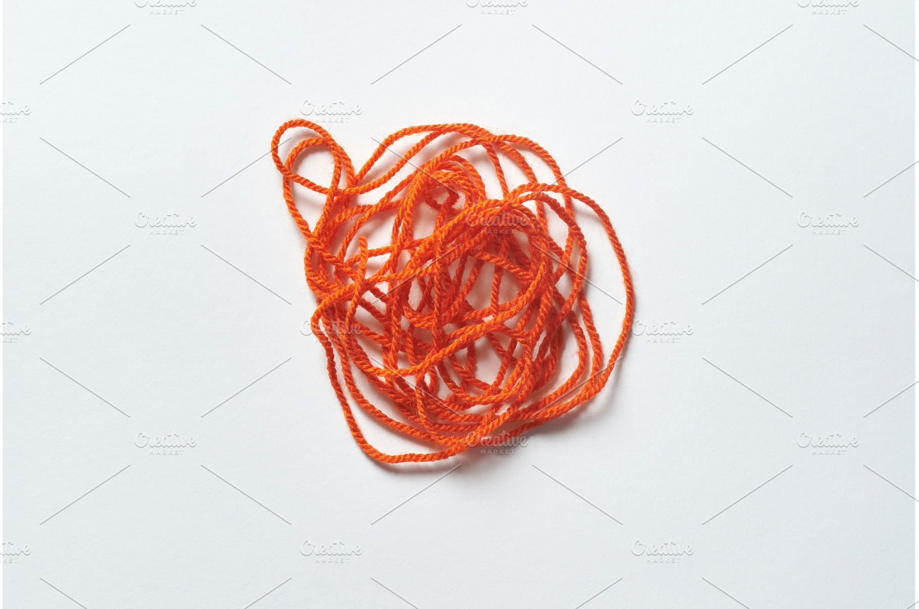 Red tangled thread on white., a Health & Medical Photo by Yaroslav Danylchenko