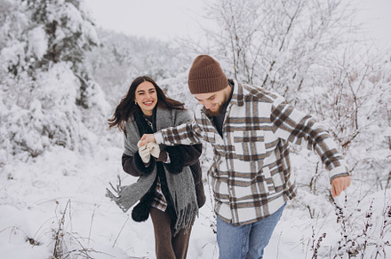 A young happy and loving couple walking in a snowy forest in the, a Person Photo by Cherkas Photography