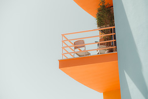 Orange Balcony on Pastel Facade