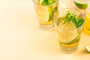 Hot mojito tea cocktail with rum, mint and lime slices, a Food & Drink Photo by Rimma