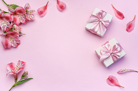 Beautiful Alstroemeria flowers and gift boxes on pink background, a Holiday Photo by Olena Rudo