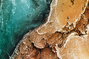 Stone texture of relief stone with a golden hue and sea color wallpaper and