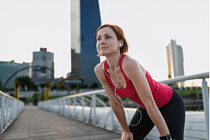 Female runner resting and catching, a Person Photo by HalfPoint