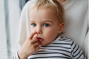 Toddler picking nose while sitting, a Person Photo by HalfPoint