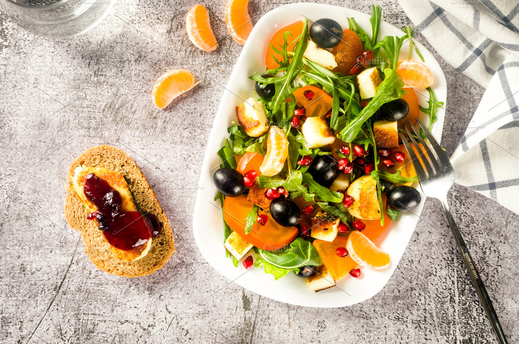 Salad with arugula, tangerines, pomegranate, grapes, and pieces, a Food & Drink Photo by vimart