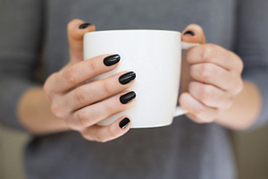 Hands holding coffee cup