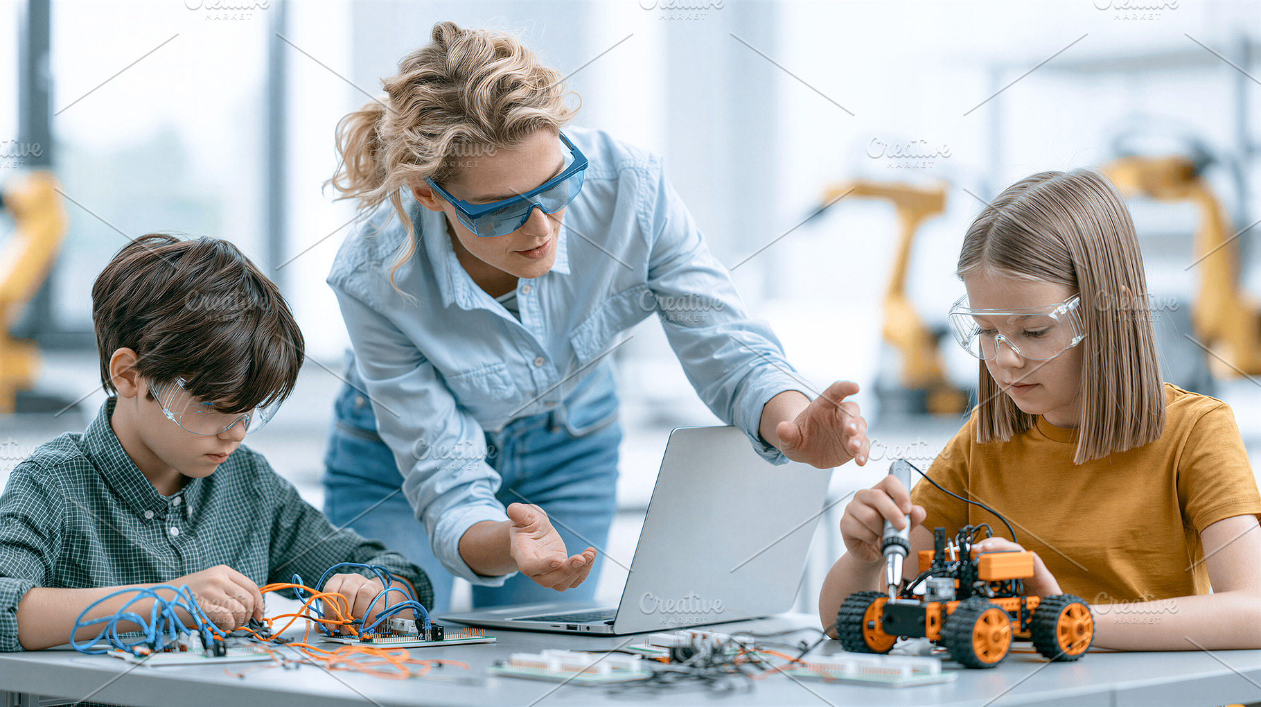 Teacher and children building robot, a School & Education Photo by 7DesignLab