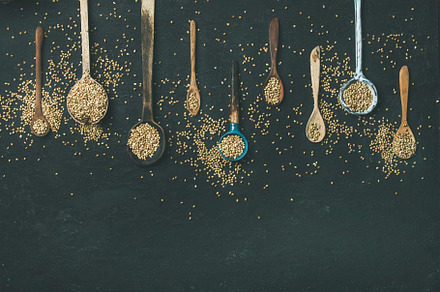 Various vintage kitchen spoons and green buckwheat grains, a Food & Drink Photo by Foxys