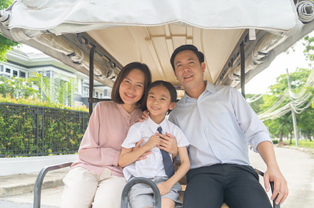 Portrait of happy smiling Asian Family living together on golf c, a Photo by Tampatra