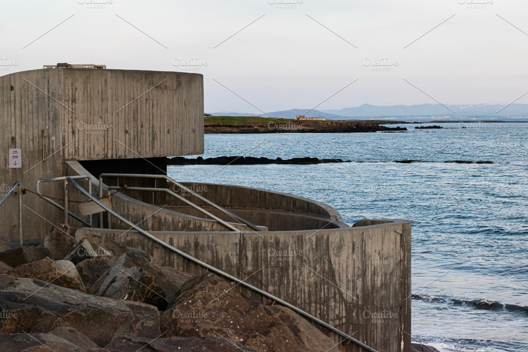 Concrete sea barrier structure along the coastline in Akranes, Iceland at sunse, a Photo by AS photostudio
