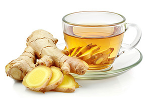 Glass cup of ginger tea with sliced ginger root isolated on whit, a Food & Drink Photo by AlyaAnd