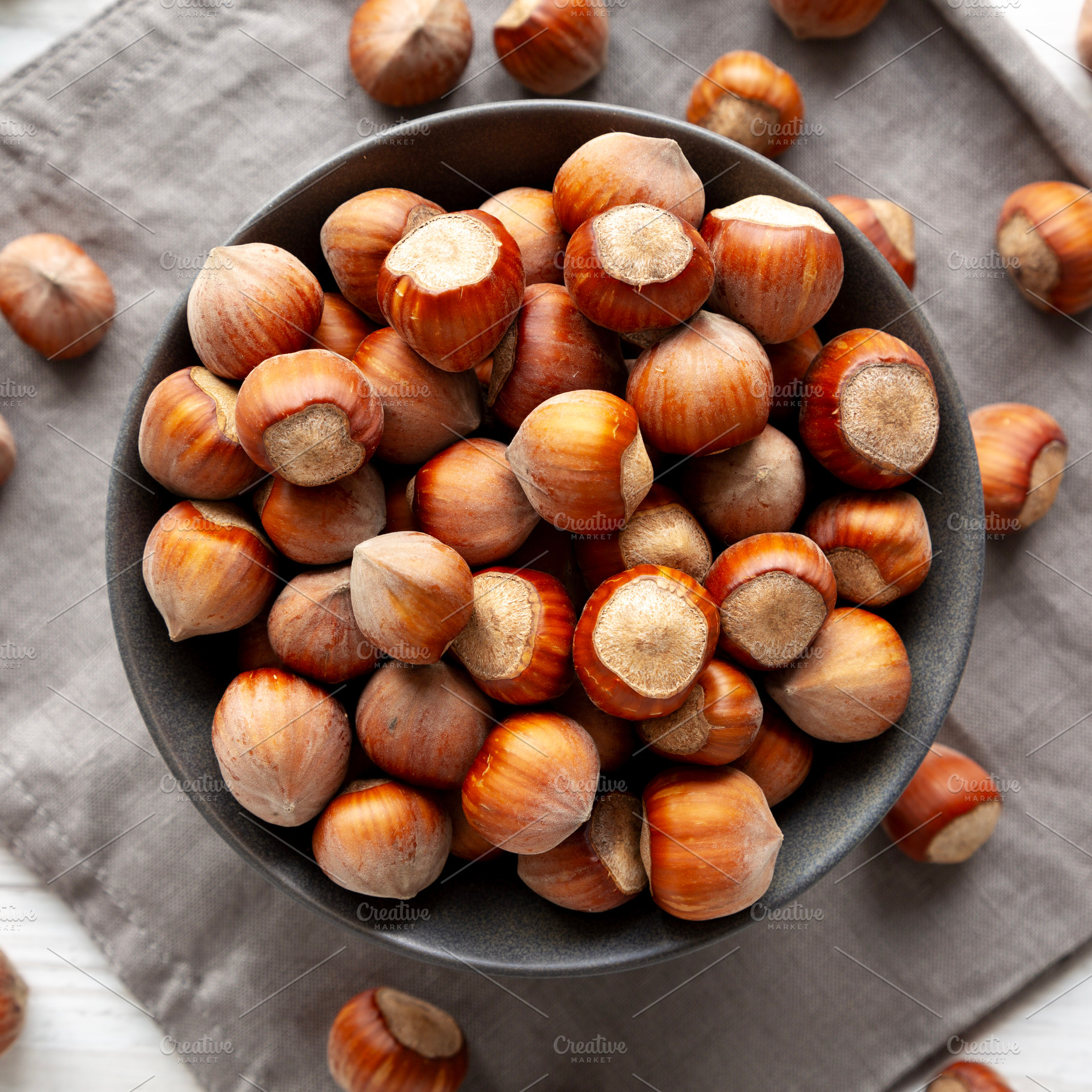 Organic Raw Hazelnuts in a Bowl, top view. Close-up., a Food & Drink Photo by LiudmylaChuhunova