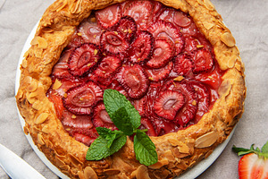Delicious homemade strawberry galette decorated with almond peta, a Food & Drink Photo by Olena Rudo
