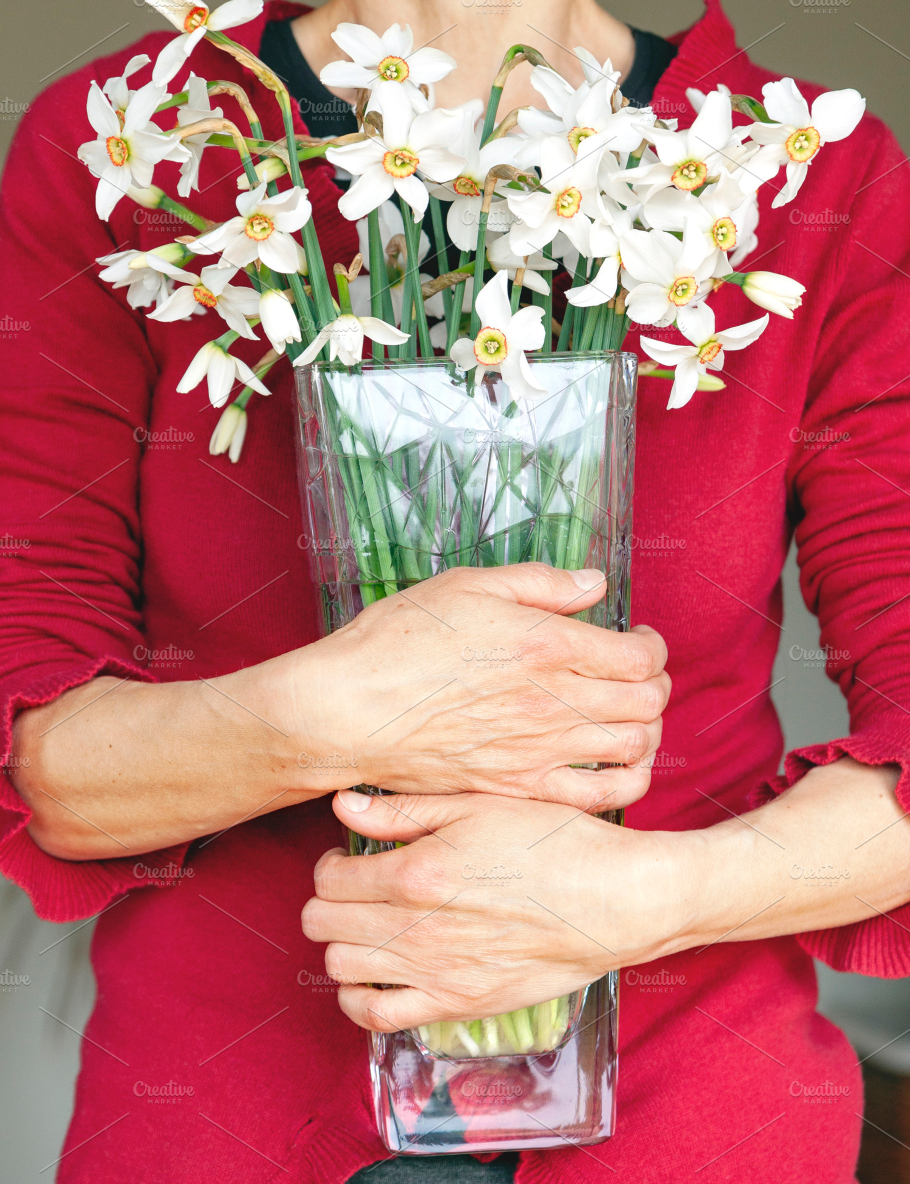 Woman holding narcissus flowers, a Person Photo by BOOCYS