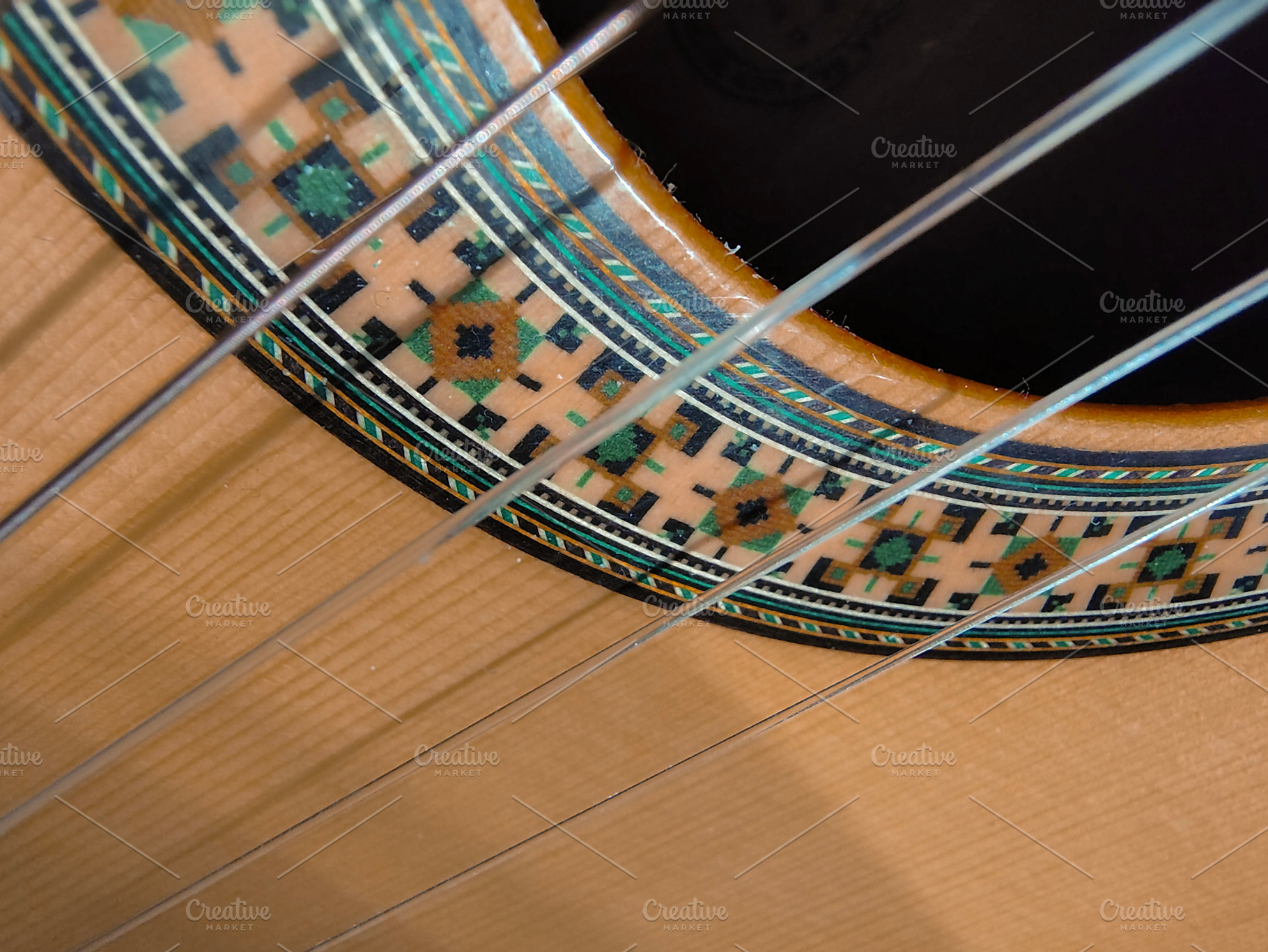 Close-up, high-angle detail shot of a classic spanish guitar, an Arts & Entertainment Photo by DanFLCreativo