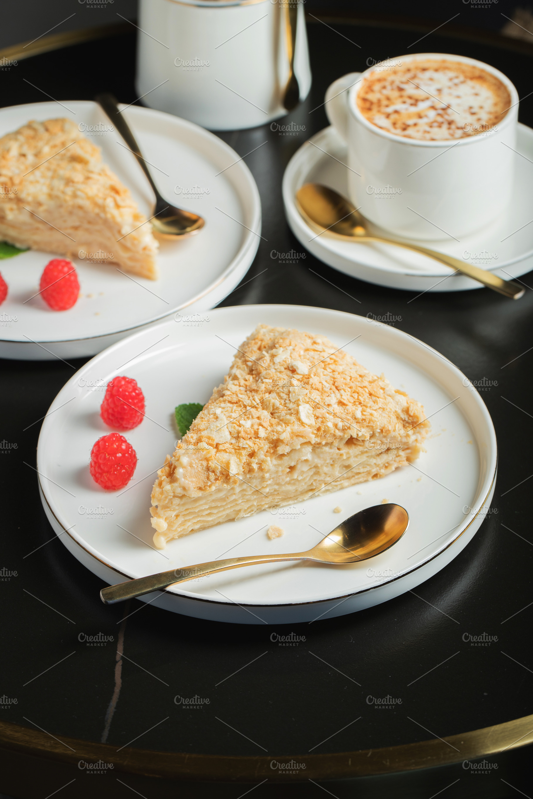Sliced Napoleon cake on a white wooden table. Classic dessert, a Food & Drink Photo by Budarinphoto