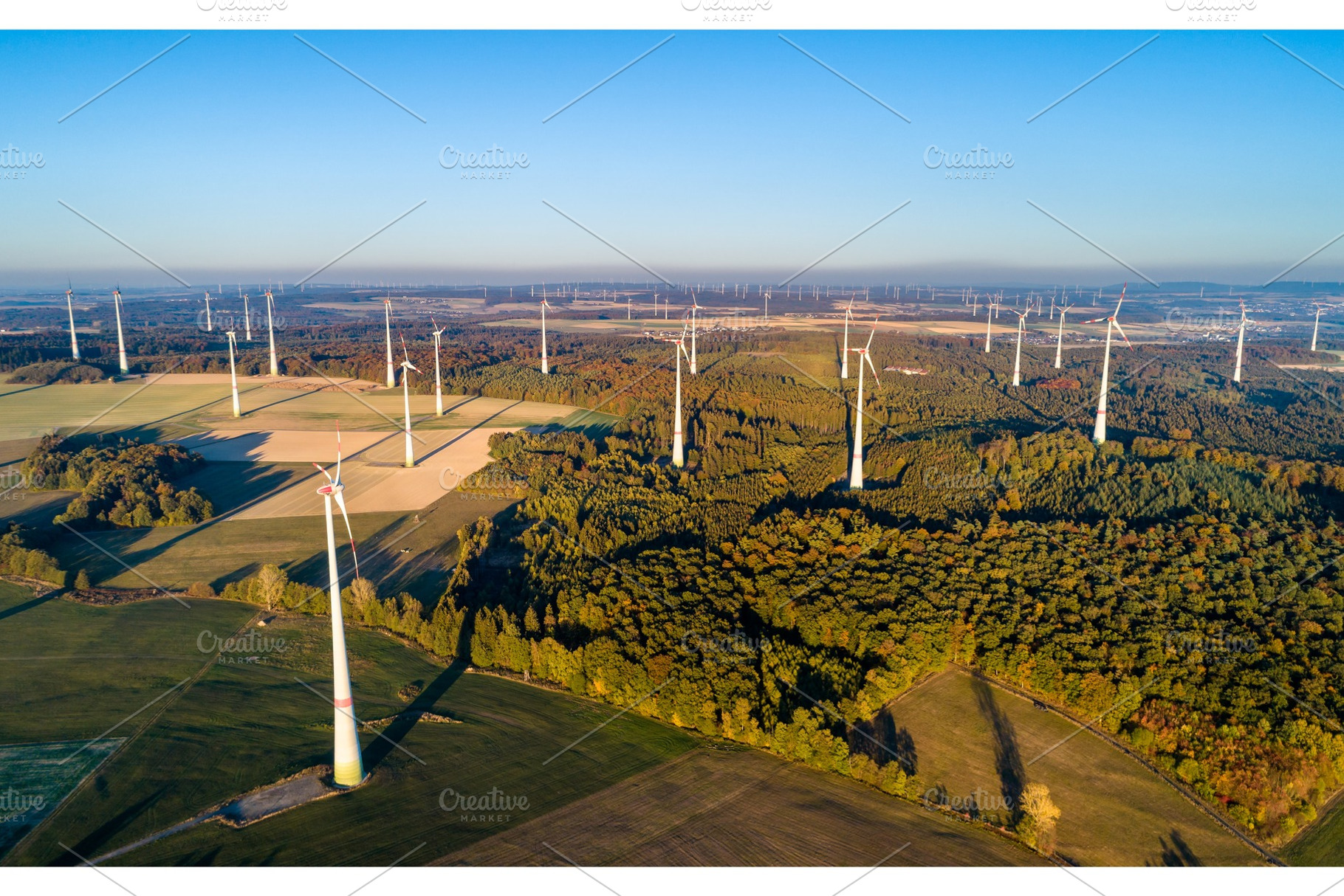 Aerial view of a wind farm in containing wind, turbine, and germany, an Industrial Photo by Leonid Andronov