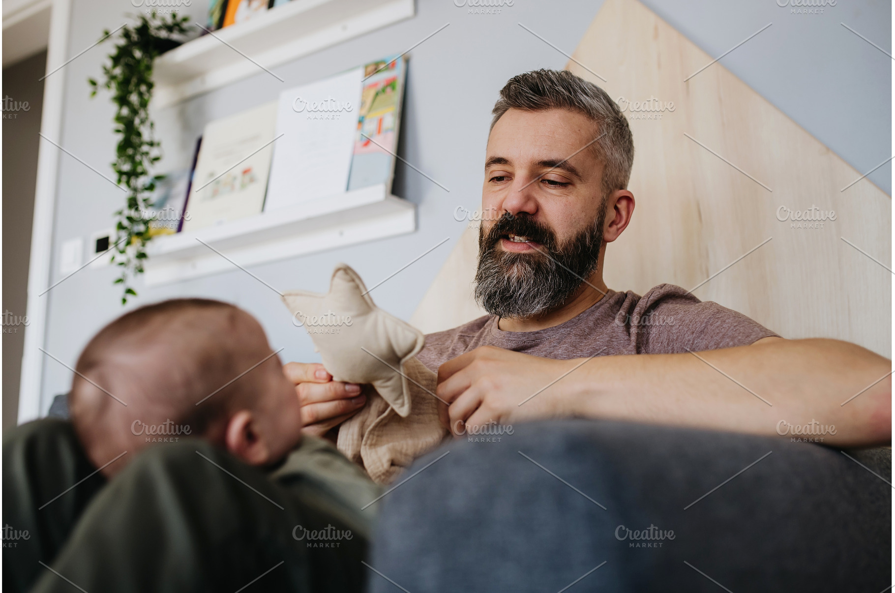 Father holding baby boy on his lap., a Person Photo by HalfPoint