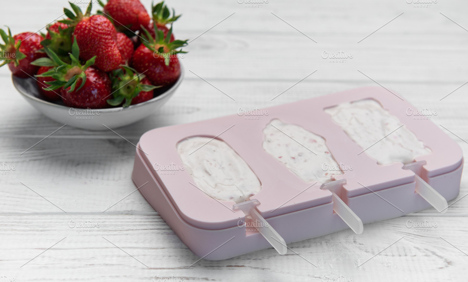 Preparing homemade strawberry yogurt popsicles on wooden backgro, a Food & Drink Photo by Olena Rudo
